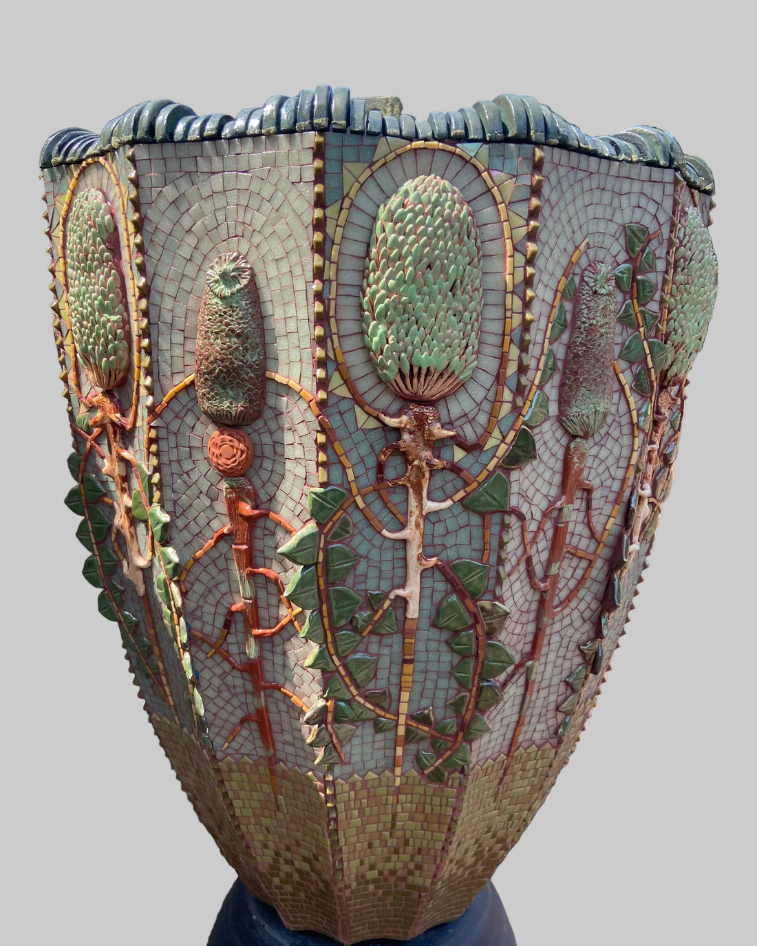 Decorative mosaic sculpture of a plant with intricate details on a planter.