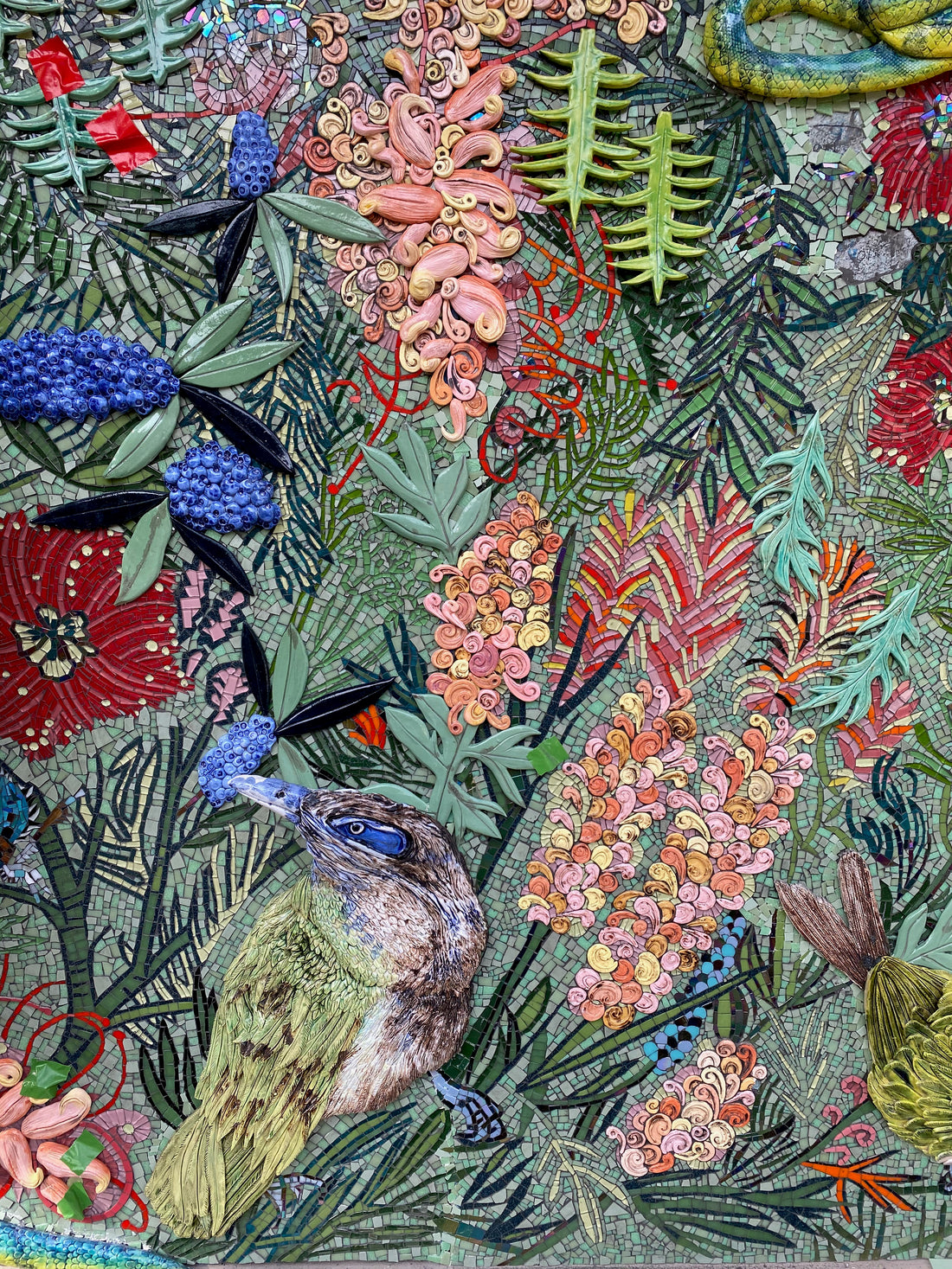 Colorful ceramic mosaic artwork of a bird and floral elements made by Jane du Rand
