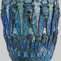 Mosaic planter with cicada design on a white surface