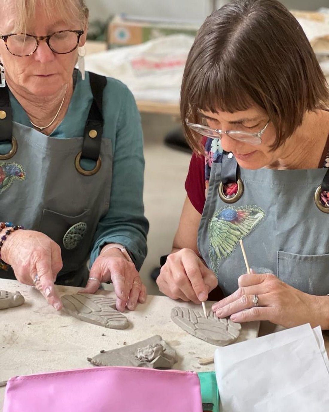 Two women working on pottery in a Jane du Rand masterclass
