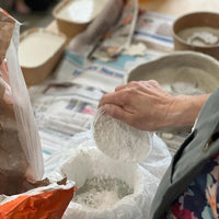 Person working with materials on a table in Jane du Rand masterclass